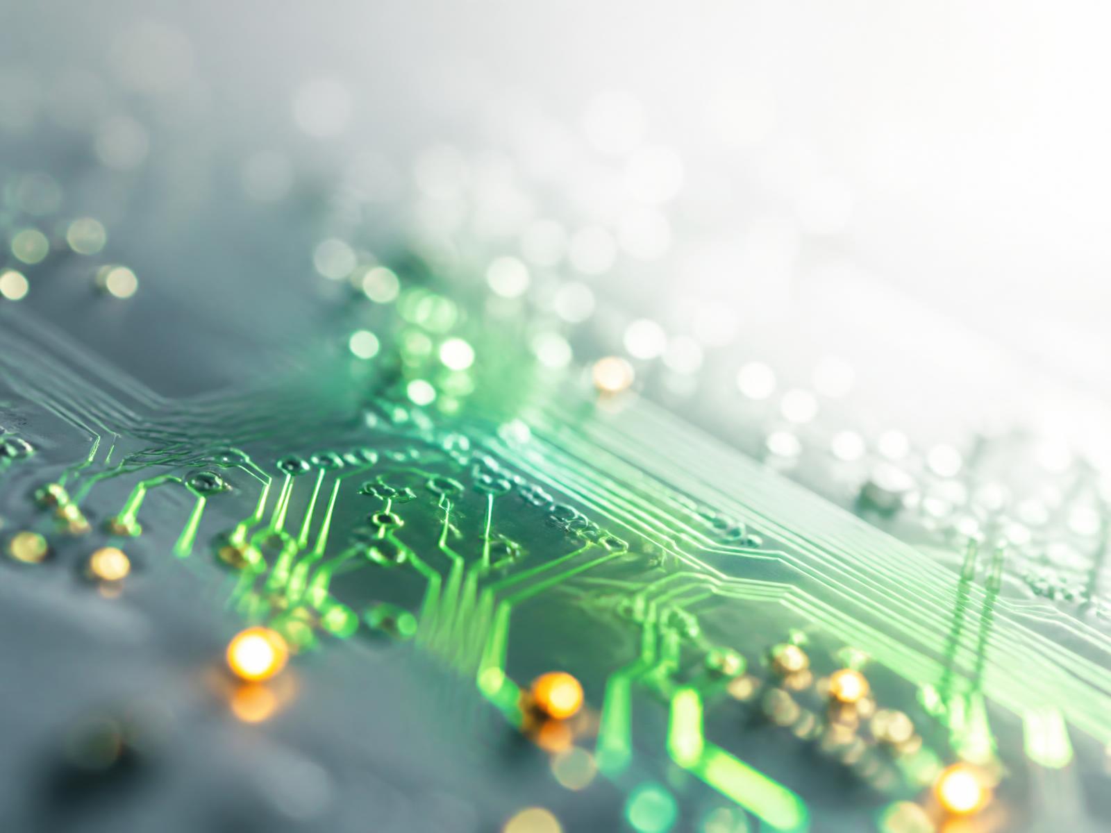Close-up of a circuit board with glowing green traces